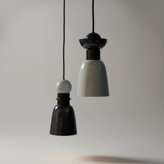 Two hanging light fixtures against an orange background