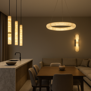 Modern kitchen and dining area with pendant and wall lights.