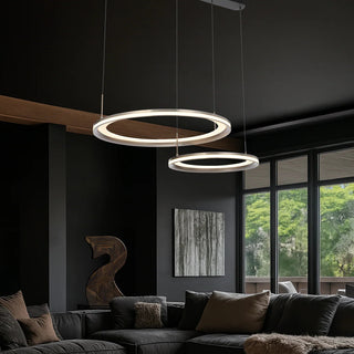 Modern living room with two circular pendant lights and a dark wall.