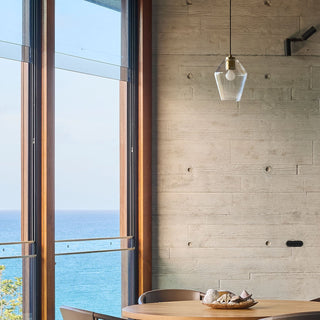 Industrial clear glass pendant light hanging above kitchen island