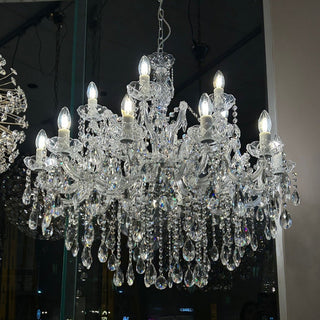Crystal chandelier with multiple lights in a darkly lit room