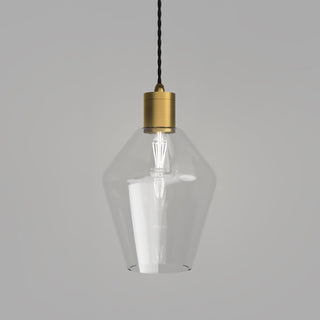Industrial clear glass pendant light hanging above kitchen island