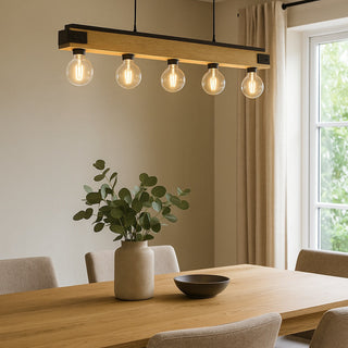 Modern dining room with a wooden table, chairs, and a pendant light fixture.