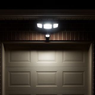 Garage door with a security light fixture above it in a dark setting