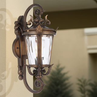 Decorative outdoor wall light fixture on a building exterior.
