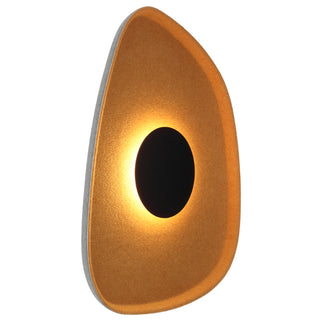 A wall light fixture with a textured surface and a circular LED light source visible through an opening in the center.