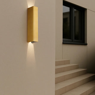 Ryland Brass outdoor wall light installed near staircase, glowing softly with warm up and down light.