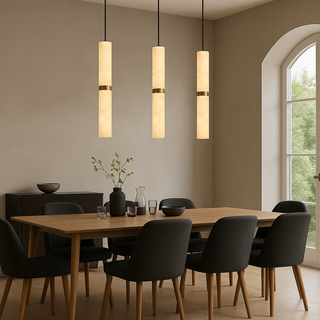 Dining room with wooden table and black chairs, illuminated by 3 marble pendant lights.