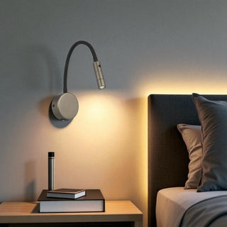 Telbix SOLIO Modern wall-mounted lamp on a bedside table next to a bed