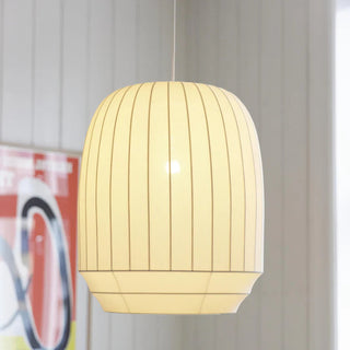 Off White pendant lamp hanging in a room with a colorful poster on the wall.