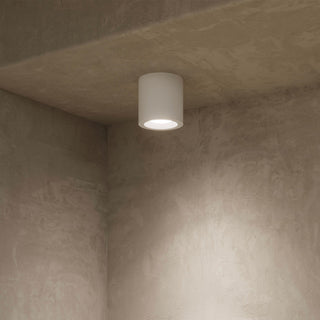 Ceiling light fixture on a textured ceiling and wall