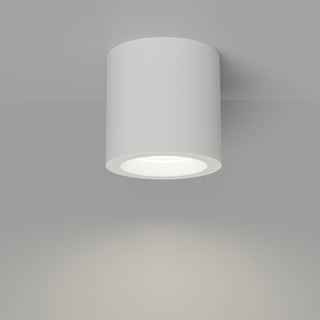 White cylindrical ceiling light fixture on a gray background