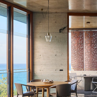 Industrial clear glass pendant light hanging above kitchen island