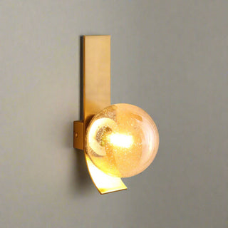 Satin brass wall light with amber glass