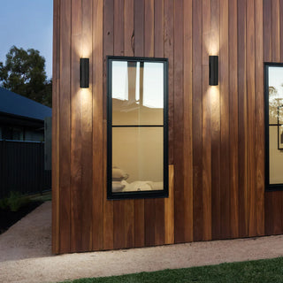 Wooden wall with two framed mirrors and wall lights