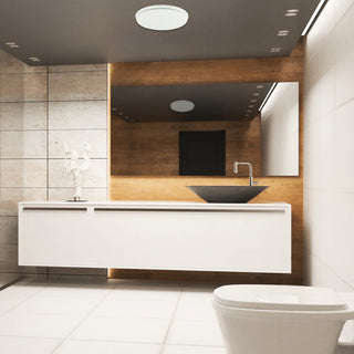 Modern bathroom with white vanity, black sink, and white toilet.