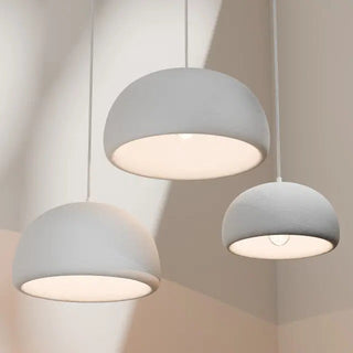 Passerine white Wabi Sabi pendant lights in three sizes illuminated