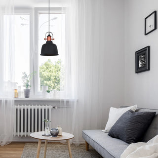 Modern living room with a gray sofa, small round table, and decorative elements.