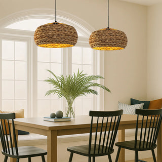 Dining room with wooden table, black chairs, and wicker pendant lights.