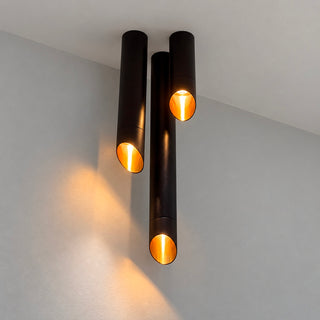 Three Pipe ceiling lights in different lengths illuminated at Davoluce showroom