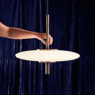 Hand adjusting UFO Pendant Light – close-up showing brushed nickel detail