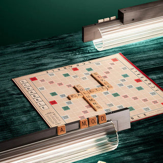 Scrabble board game with letter tiles on a green surface