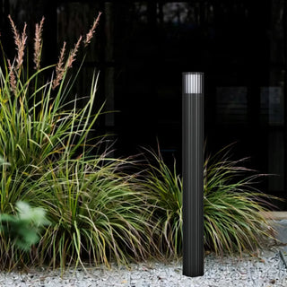 Black Telbix Cashel bollard light installed beside garden pathway