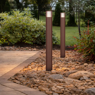 Weathered Rust Cashel bollard lights illuminating landscaped outdoor area