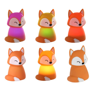 Set of colorful fox-shaped night lights on a white background