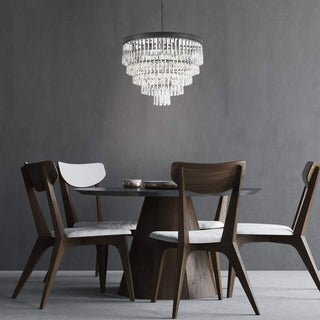 Cascata crystal pendant suspended above a round dining table in a contemporary dining room.