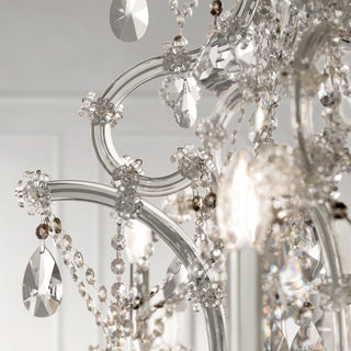 Close-up of a chandelier with crystal details against a neutral background