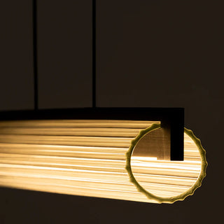 Close-up of Column Linear Pendant Light lit in warm 3000K with fluted glass detail