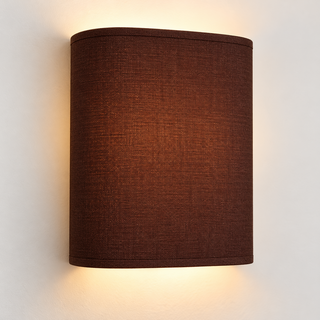 Chocolate fabric wall light with rounded corners and matching trim, illuminated