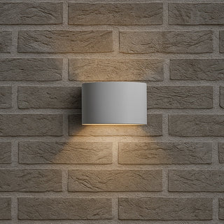 Wall-mounted outdoor light fixture on a brick wall