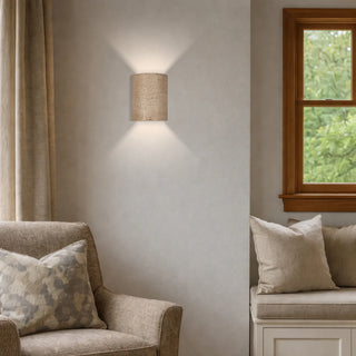 Etruso wall sconce cast stone cylindrical design warm ambient lighting Davoluce showroom