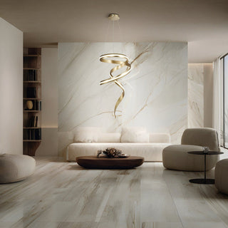 Camila sculptural gold LED pendant installed in a modern living room
