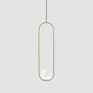 Gold pendant light with a white bulb on a light gray background