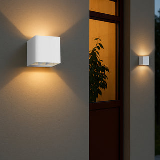 Telbix Flip II white exterior wall light installed beside window showing warm LED illumination