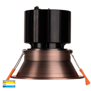 Black and copper metal lamp with orange accents on a white background