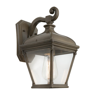 Bronze outdoor wall light fixture with clear glass on a white background