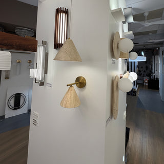 Genuine travertine stone cone wall light in beige finish displayed at Davoluce Lighting showroom