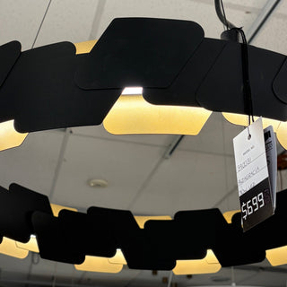 Large black and gold LED statement pendant on showroom display