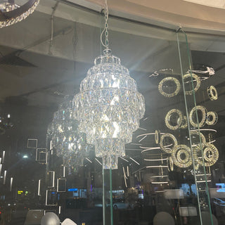 Chandelier illuminating double-height foyer space