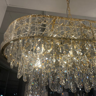 Crystal chandelier with gold accents hanging from the ceiling.