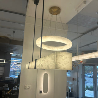 Modern floor lamp with a round light fixture in a room setting.