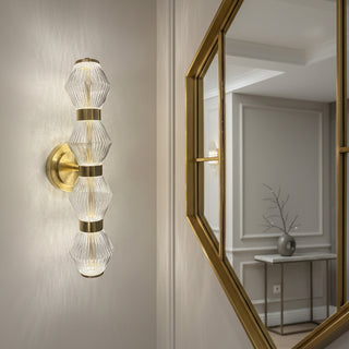 Gold and glass wall sconce on a white surface