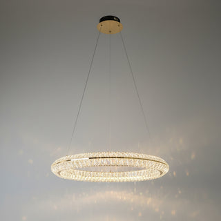 Chandelier hanging from a ceiling with a dark curtain in the background