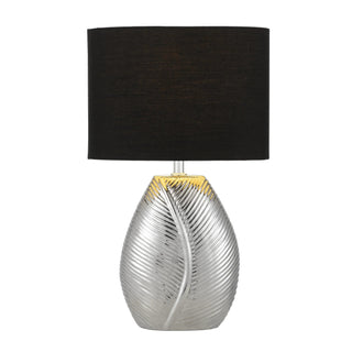Decorative table lamp with a black shade and silver base on a white background