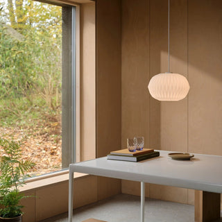 Aviana pendant light installed above table warm ambient lighting opal glass