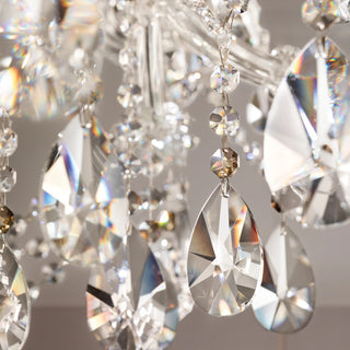 Close-up of a chandelier with crystal prisms on a neutral background